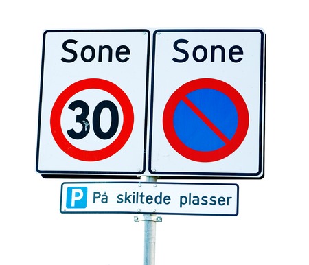 Norwegian road signs for a zone with speed limit 30 kph and parking prohibited exept for maret parking lots.の写真素材