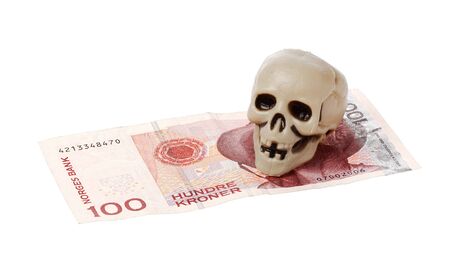 Norwegian 100 kroner bill with a small plastic scull isolated on white background.の写真素材