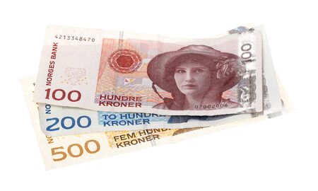 Three Norwegian banknotes of different denominations stacked with the one hundred bill on top and isolated on white background.の写真素材
