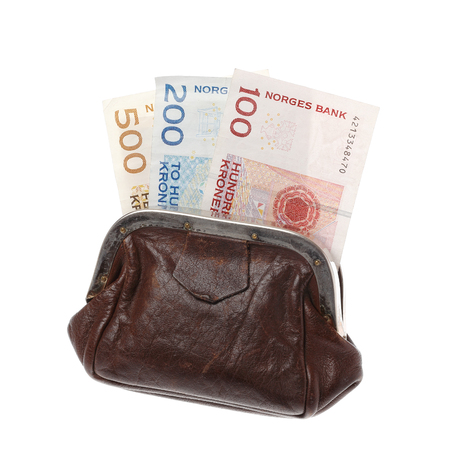 One brown purse with three Norwegian banknotes in the demonitations of 100 200 and 200 kroner isolated on white background.の写真素材
