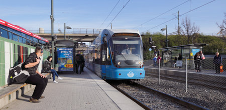 Stockholm, Sweden - April 29, 2014: Passengers ready to embark the incomming tram at the the Arstaberg tram stop.のeditorial素材