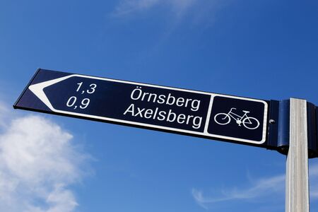 Signposts for cyclists with a distance of neighborhoods Ornsberg and Axesberg in Stockholm.の写真素材