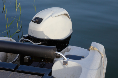 Close up of an outboard motor on a small boat.の写真素材