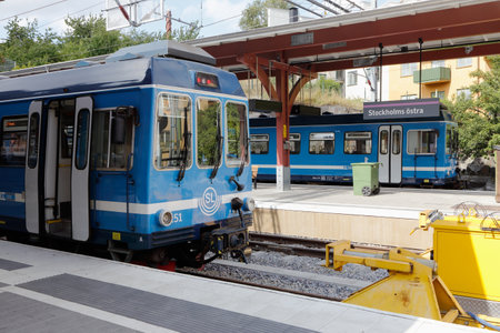 Stockholm, Sweden - July 28, 2016: Blue commuter trains at the terminal station Stoclkholm East station (Stockholms Ostra) end terminal for the suburban narrow gauge Roslagsbanan railway system.のeditorial素材