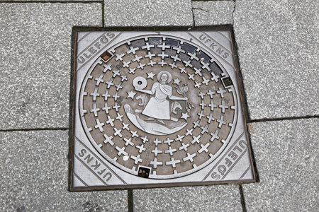 Manhole cover with the symbol for the city of Oslo, Norway.のeditorial素材