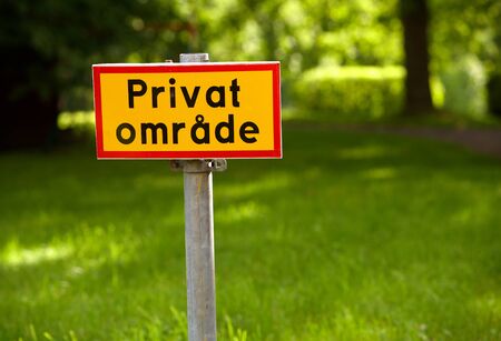 Yellow sign with red frame and text in Swedish specify Private Area.の写真素材