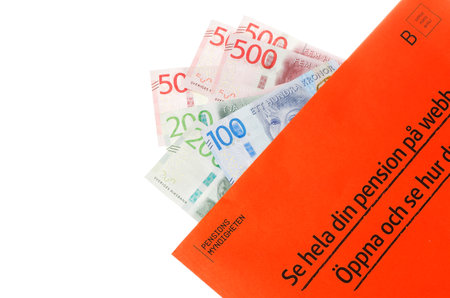 Stockholm, Sweden - March 3, 2017:The orange envelope from the Swedish Pensions Agency (Pensionsmyndigheten) with teh annual statement on top of Swedish banknotes.のeditorial素材