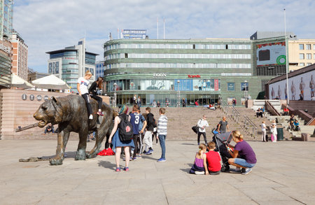 Oslo, Norway - September 16, 2016: A group of young people around and tw sitting on the sculpture Tiger (Tigeren) made by Elena Engelsen at tbe square Jernebanetorget in downtown Oslo.のeditorial素材