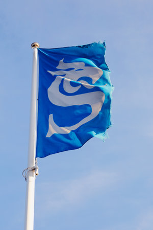 Sundsvall, Sweden - July 24, 2016: The flag with the symbol of the Sundsvall municipality raised on on flagpole.のeditorial素材