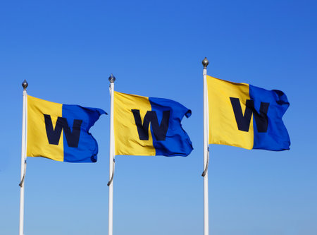 Stockholm, Sweden - April 22, 2014: The Stockholm archipelago boat service company Waxholmsbolaget flags against a blue sky at Sluusen in Stockholm.のeditorial素材