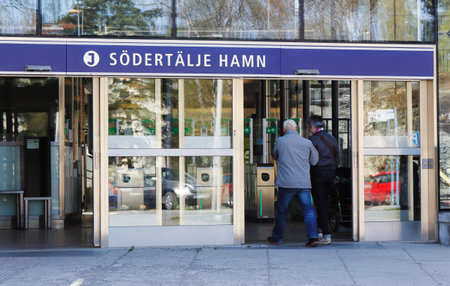 Sodertalje, Sweden - April 26, 2014: Entrance to the public transport commuter train station Sodertalje hamn with a person passing through the doorのeditorial素材