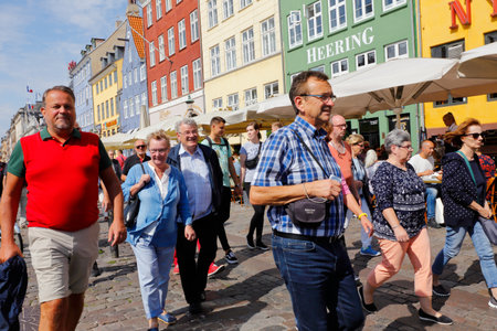 Copenhagen, Denmark - August 24, 2017: People walking in sunshine in Nyhavn.のeditorial素材