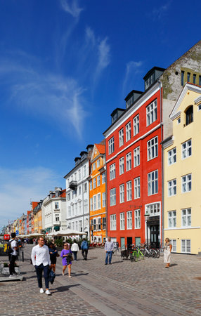 Copenhagen, Denmark - August 24, 2017: Street view of the colorful building in Nyhavn in Cophenhagen with people walking the street in front.のeditorial素材