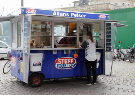 Copenhagen, Denmark - August 24, 2017: A female customer at the mobile hotdog cart in central Copenhagen.のeditorial素材