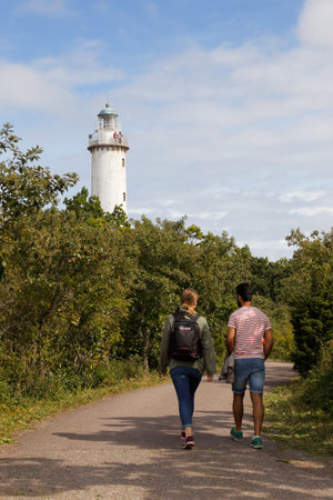 Byxelkrok, Sweden - August 22, 2017: A couple walking towards the lighthouse Lange Erik at the Swedish province of Oland north end.のeditorial素材