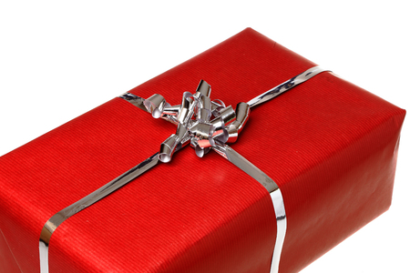 Gift with red wrapping paper isolated on white background.の写真素材
