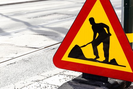 Road sign warning for road work at a street with tram track..の写真素材