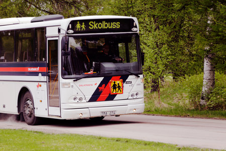 Sarna, Sweden - May 27, 2013: A school bus from Dalatrafik leaves the school in Sarna with schoolchildren at the end of the school day.のeditorial素材