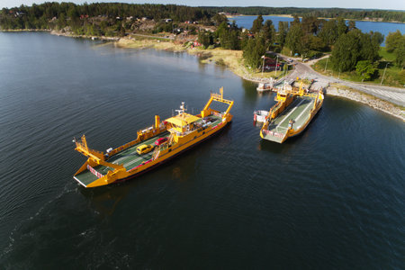 Horningsnas, Sweden - May 22, 2018: Aerial view of a yellow road ferry operateded by the Swedish...