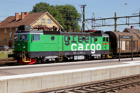 Kristinehamn, Sweden - June 8, 2018: A green electric locomotive class Rd2 in service for the Swedish state Green Cargo railway company pulls a freight train.のeditorial素材