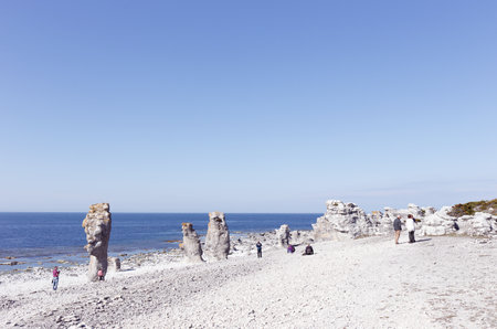 Faro, Sweden - May 13, 2016: People at the sea stacks located at Langshammars in the Swedish province of Gotland.のeditorial素材