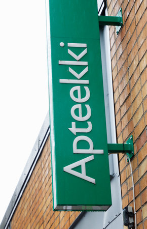 Kemi, Finland - June 19, 2018: The green sign outside the Finnish pharmacies Yliopiston Apteekki located at 7 Pohjoisrantakatu in downtown Kemi.のeditorial素材