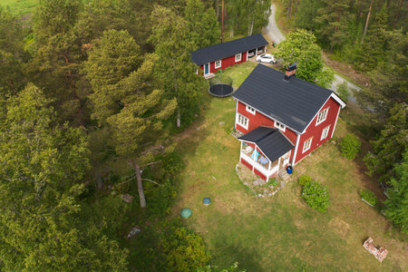Ranea, Sweden - June 16, 2018: Aerial view of a red painted two stories one family house built during the 1930s located on the countryside.のeditorial素材