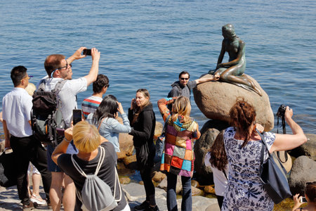 Copenhagen, Denmark - June 27, 2018: Tourists infront of the bronze statue of the Little Mermaid, by Edvard Eriksen, located at Langelinie.のeditorial素材
