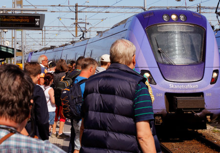 Ystad, Sweden - June 26, 2018: One blue public transportation train class X61 in service for Skanetrafiken with destination Helsingborg via Malmo arriving Ystad railroad station on track 4 with passengers waiting..のeditorial素材
