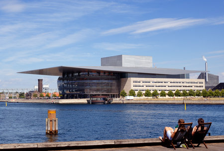 Copenhagen, Denmark - June 27, 2018: Twho person in deck chairs in front of the Copenhagen opera house.のeditorial素材