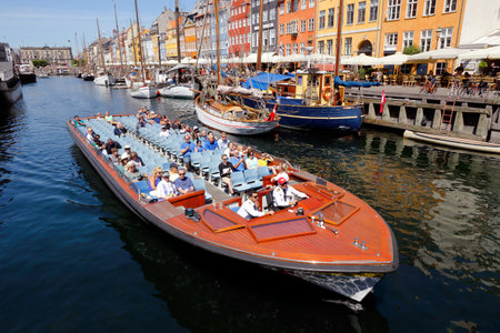 Copenhagen, Denmark - June 27, 2018: A n open top sigthseeing boat with tourists in Nyhavn old port on a guided canal tourのeditorial素材