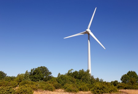 Wind turbine against a blue sky.の写真素材
