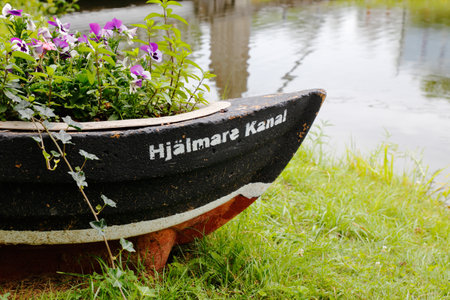 Hjalmare docka, Sweden - July 9, 2018: Close-up of flower pot shaped like a boat with the text Hjalmare Kanal.のeditorial素材