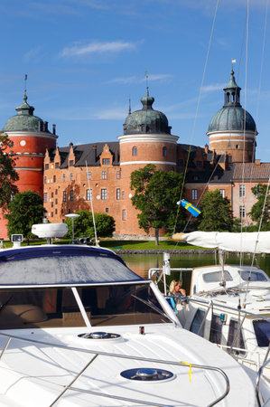 Mariefred, Sweden - July 29, 2017: Pleasure boats in front of the red colored Gripsholm castle in the province of Sodermanland.のeditorial素材