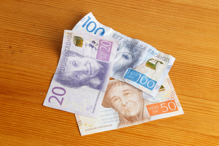 Stockholm, Sweden - March 3, 2017: Swedish valid banknotes 20, 50 and 100 krona on a wooden table.のeditorial素材