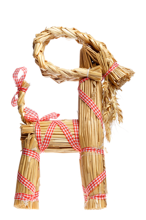 Side view of a traditional straw billy goat christmas decoration isolated on white.の写真素材