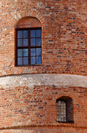 Two windows in the red brick wall in one of the castle towers.の写真素材