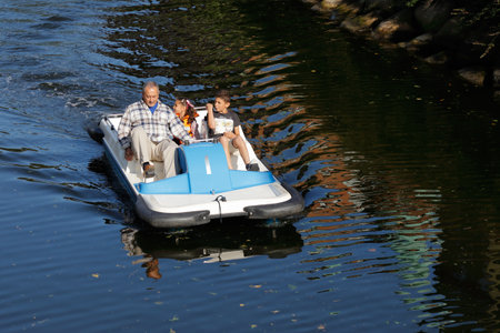 Malmo, Sweden - August 23, 2017: One adult and two kids in a blue and white pedalo.のeditorial素材