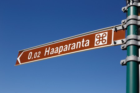 Signpost in Finland written in Finnish with the distance i km to the Swedish town Haparanda.の写真素材