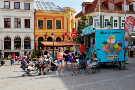 Ystad, Sweden - June 26, 2018: People visiting an mobile ice cream kiosk selling the Ottoglass brand...
