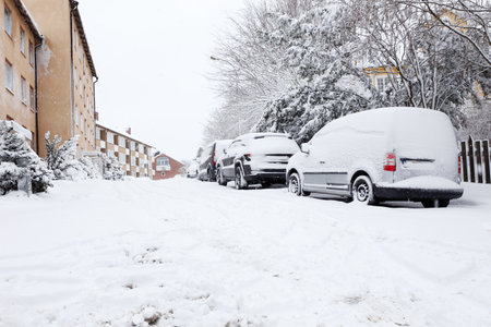 City street in a residential district during the end of a snowfall.のeditorial素材