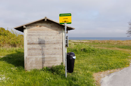 Ljugarn, Sweden - May 14, 2016: Bus stop at Ljugarn with wooden shelter.のeditorial素材