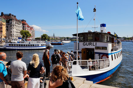 Stockholm, Sweden - July 12, 2018: Public transportation boat Gurli in service on SL line 80 at the Nybroplan stop.のeditorial素材