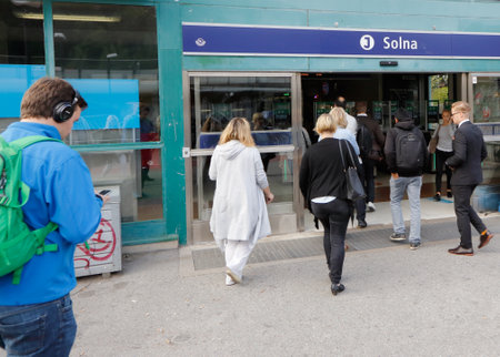 Solna, Sweden - September 14, 2016: People walking towards the entrance of the Solna comuter train station.のeditorial素材