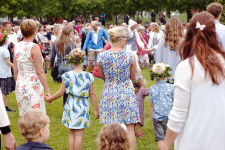 Mariefred, Sweden - June 24, 2016: People participate in the public traditional celebration of the midsummer holiday dancing around the midsummer pole.のeditorial素材