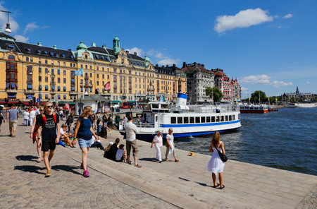 Stockholm, Sweden - July 12, 2018: The Nybroplan area with people in front of the public transportation ferry.のeditorial素材