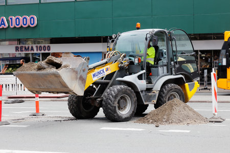 Copenhagen, Denmark - August 24, 2017: A front loader in work at a roadwok at Norreport.