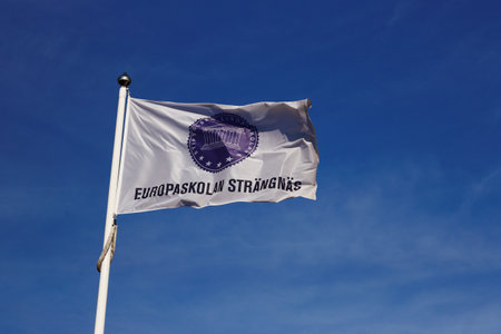 Strangnas, Sweden - June 5, 2019: Close-up of the Europaskolan school flag against the blue sky.のeditorial素材
