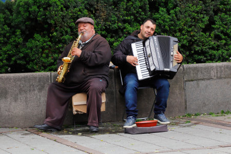 Oslo, Norway - June 20, 2019: Two street musicans near the National Theatre metro station playing a saxophone and an accordion.のeditorial素材