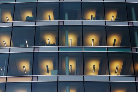 Low angle view of a modern office building with fluorescent lighting indoors.の写真素材